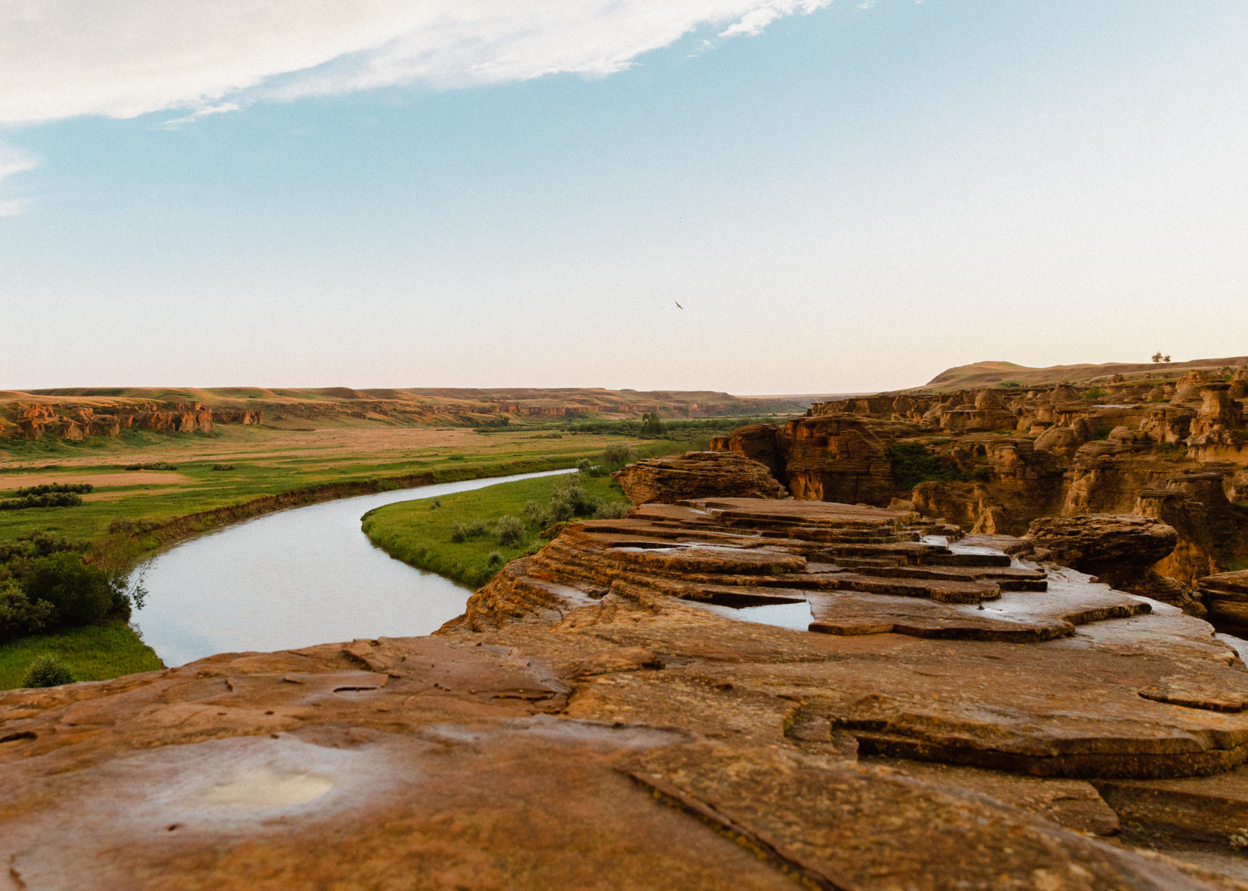 Landscape of Áísínai’pi (Writing-on-Stone) with hoodoos and river running into the distance